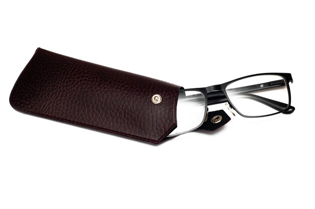 Black vision glasses in a brown leather case isolated