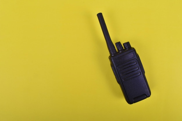 Photo a black walkie talkie on a yellow background