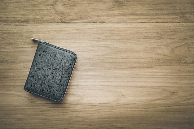 Black wallet on wood