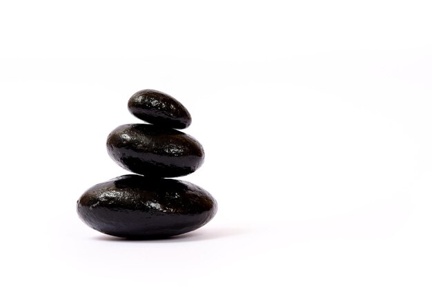 Black wet stones on white background