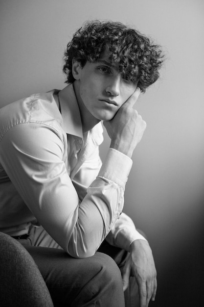 Black and white analog portrait of handsome man posing indoors