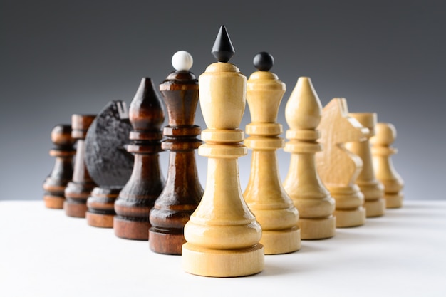 Black and white chess pieces on a table