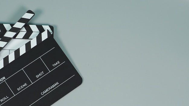 Photo black and white clapperboard or clapper board or movie slate use in video production ,film, cinema industry on gray background.