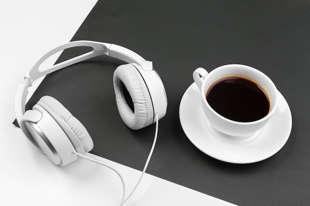 Black and white composition with stylish headphones, flat lay