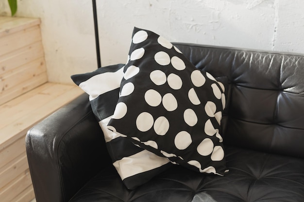 Black and white cushions on a sofa modern furniture loft interior