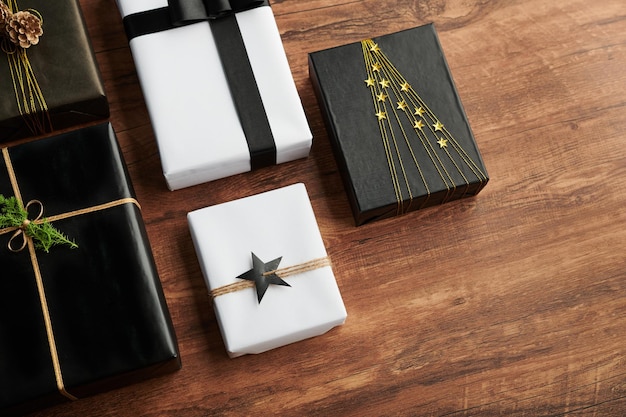 Black and white decorated boxes on wooden table prepared for celebration