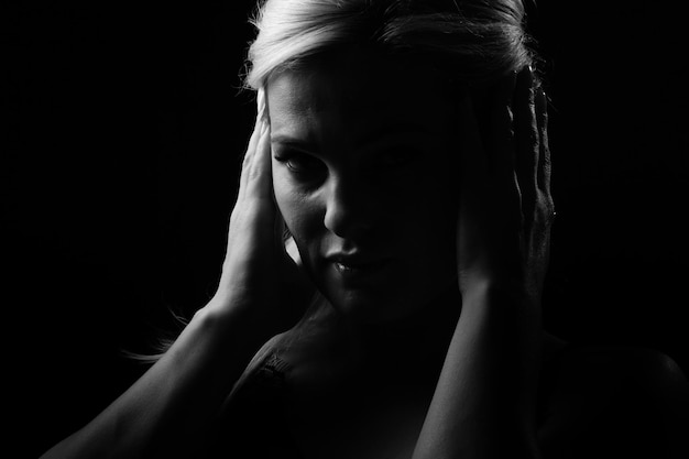 Black and white glamor woman portrait, dark beautiful face, female isolated on black background, stylish sexy look, young lady studio shot