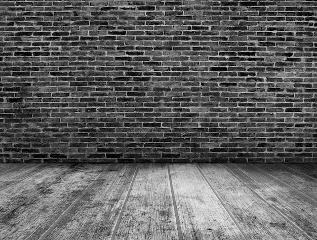 Black and white grunge room interior with brick wall background