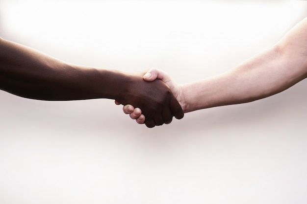 Black and white hands holding each other