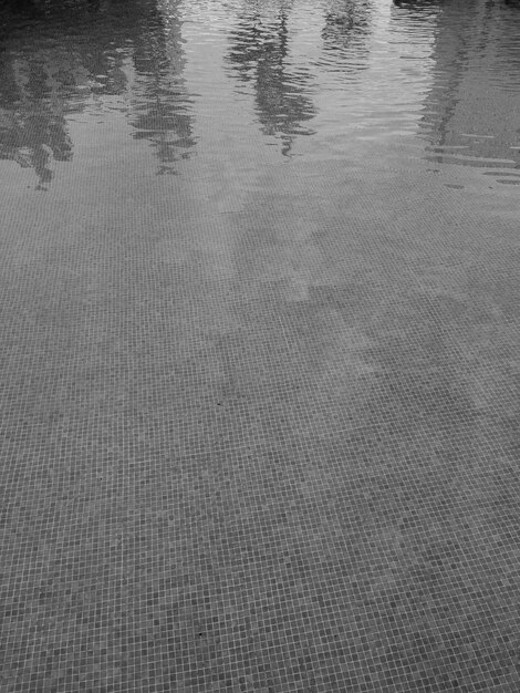 Photo black and white image of calm water with subtle ripples reflecting light textured underwater surface