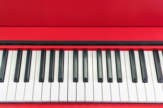 Black and white keys piano red close-up with space for text