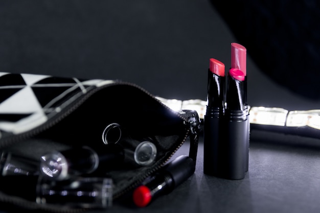 Black and white make up bag with set of lipsticks. 