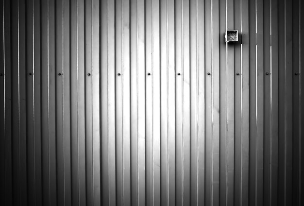 Black and white metal fence with empty socket background