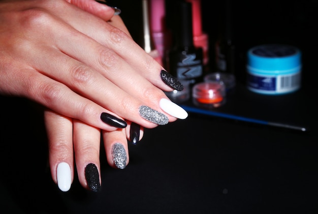 Black, white Nail art manicure. Holiday style bright Manicure with sparkles. Beauty hands. Stylish Nails, Nail Polish