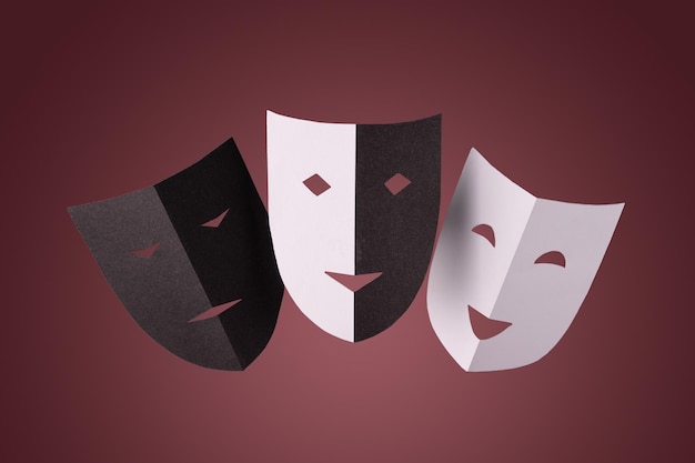 Black and white paper theater masks on a red background minimalistic photo