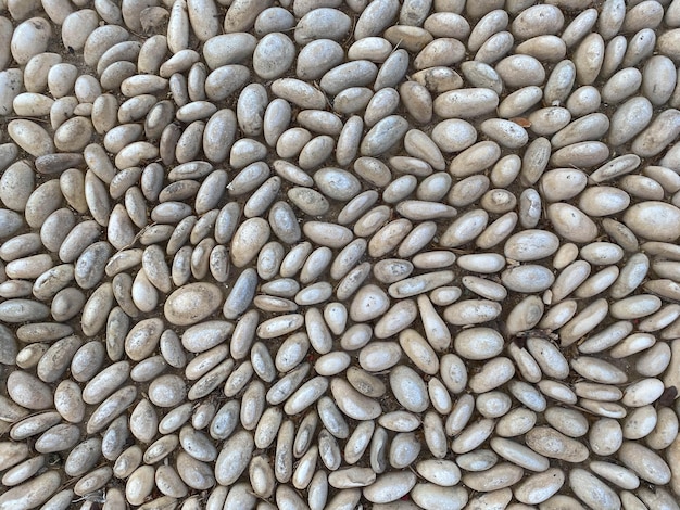 Black and white pebbles that are not neatly arranged background and texture