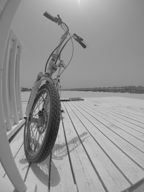 Foto foto in bianco e nero di una bicicletta sulla spiaggia