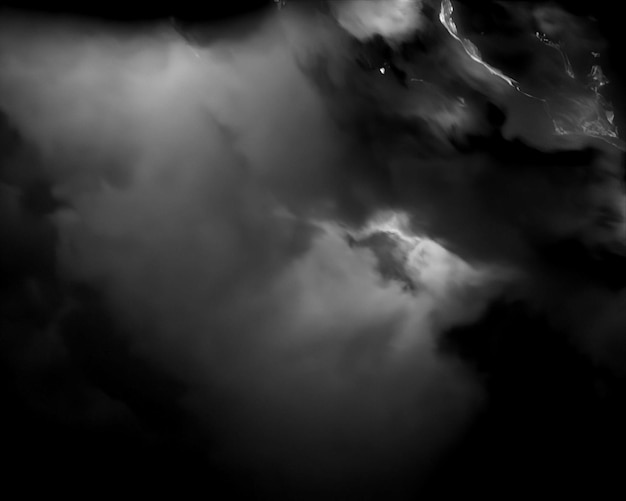 a black and white photo of a body of water with a few clouds in the background