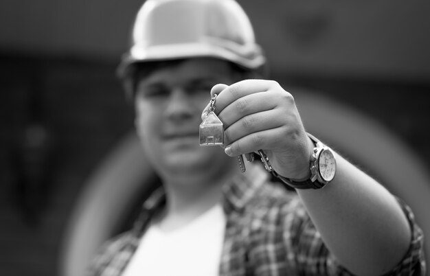 Black and white photo of building manager giving keys from new house