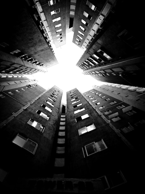 A black and white photo of a building that has the sky in it.