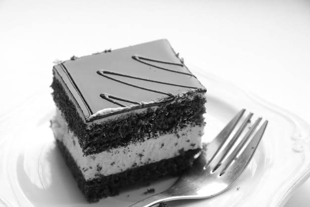 Black and white photo Delicious cake on a plate Sweets for tea or coffee