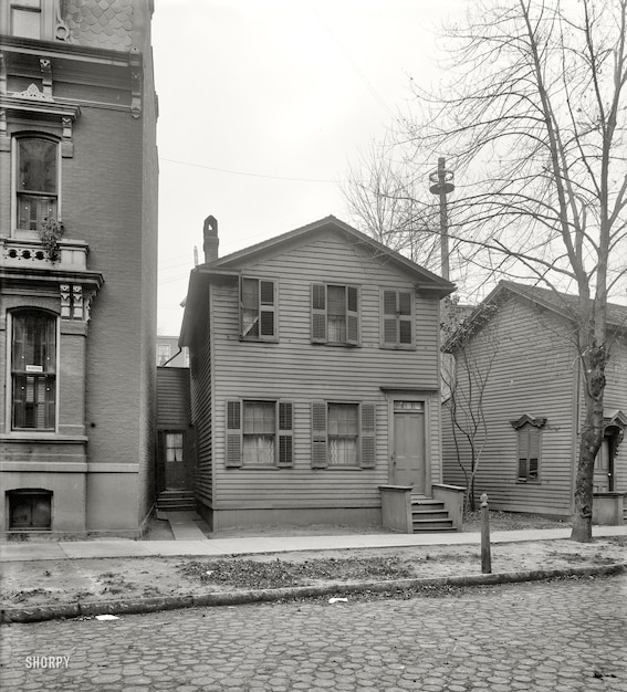 a black and white photo of a house with a sign that says  old