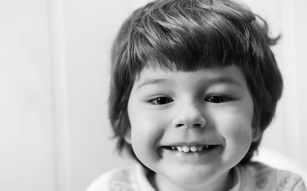 Black and white photo of  kid smiling and have fun white background