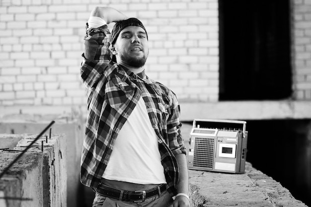 Black and white photo of a man dressed in hip hop style