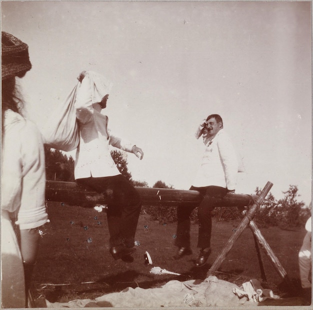 a black and white photo of a man and woman with a scarf around his head