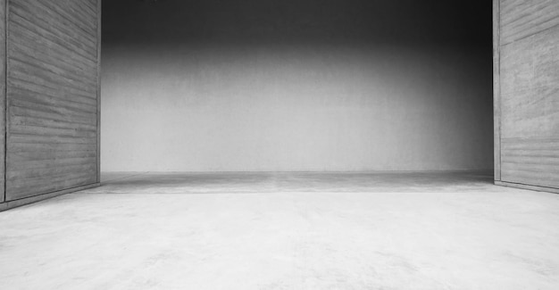 A black and white photo of a white wall with a light on it.