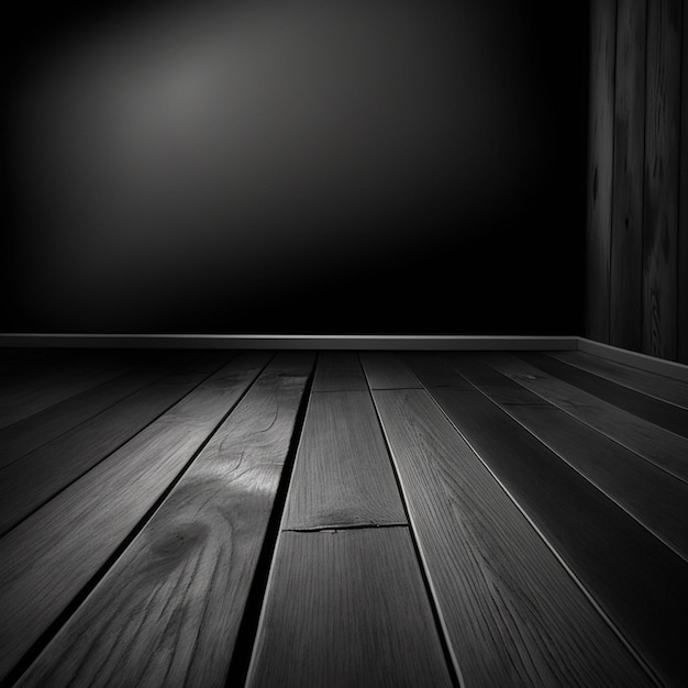 A black and white photo of a wooden floor with a wooden floor and a dark wall behind it.