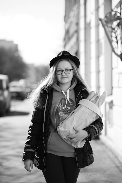 Black and white photo of a young girl on a walk