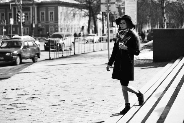 Black and white photo of a young girl on a walk