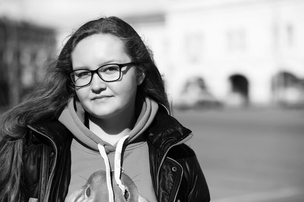 Black and white photo of a young girl on a walk