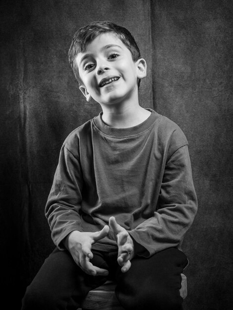 Black and white portrait of a happy boy indoor photo