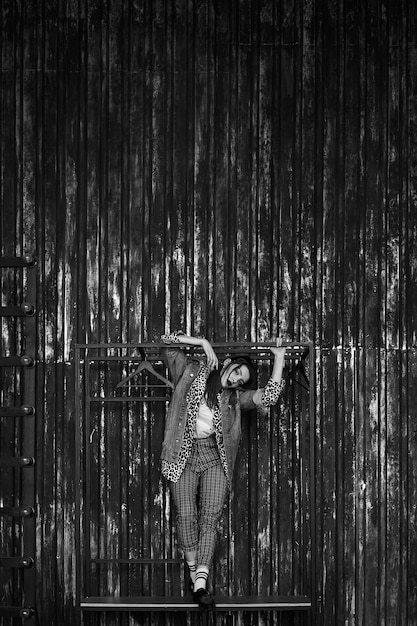 Black-white portrait of a sexy girl in grunge style. Dramatic black and white photo of a beautiful woman on a dark