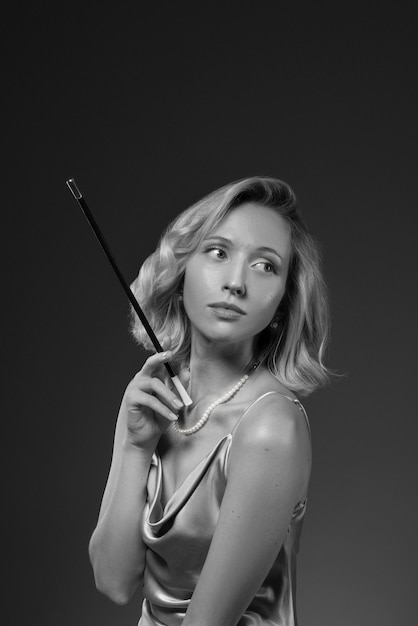 Black and white portrait of woman with cigarette in old hollywood glamour style