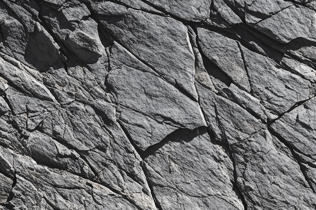 Photo black white rock texture dark gray stone granite background for design rough cracked mountain surf