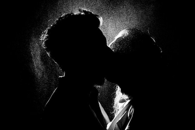 Black and white silhouette of a kissing couple