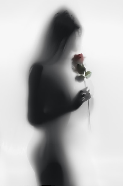 Foto sagoma in bianco e nero di una giovane donna che odora di rosa