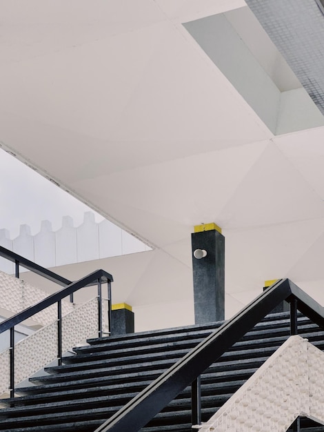 A black and white staircase with a yellow stripe on the top.