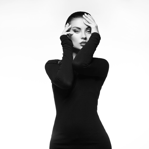 Foto ritratto in bianco e nero dello studio di una bella donna elegante in un classico abito nero.