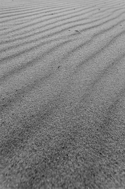 A black and white super texture and repetitive background of the sand of the beach with a great pattern