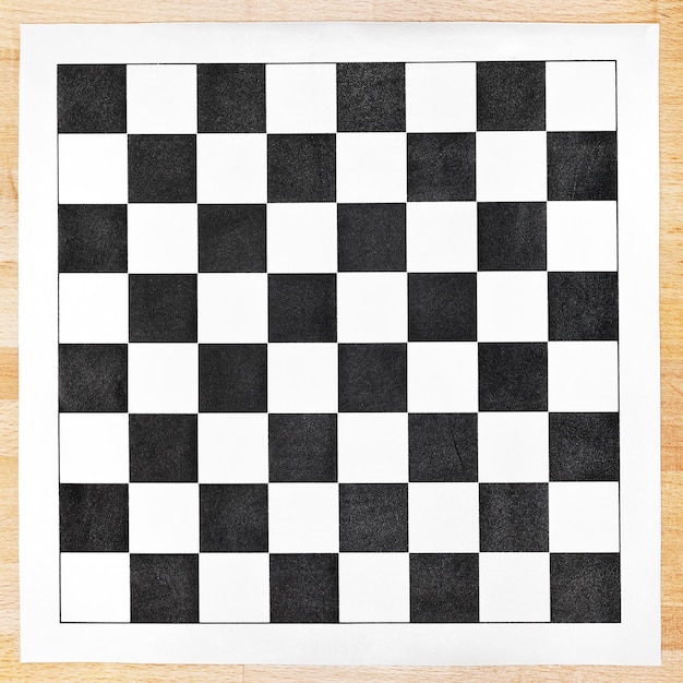 Black and white vinyl checkerboard on wooden table