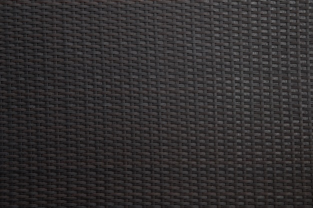 Black wicker background with rough texture