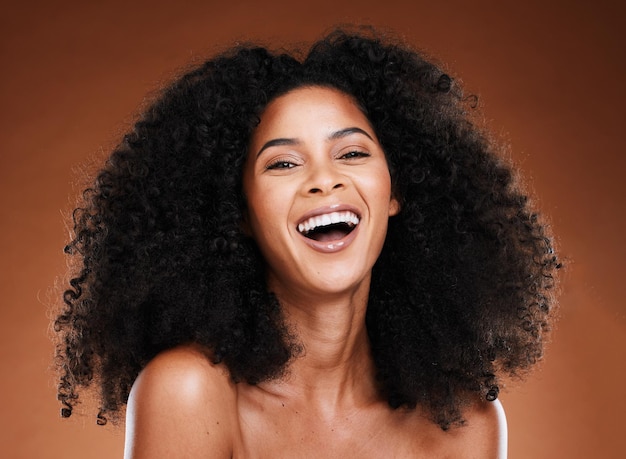Black woman afro beauty and smile for skincare makeup or cosmetics against a studio background Portrait of African American female model smiling in happiness or satisfaction for perfect skin