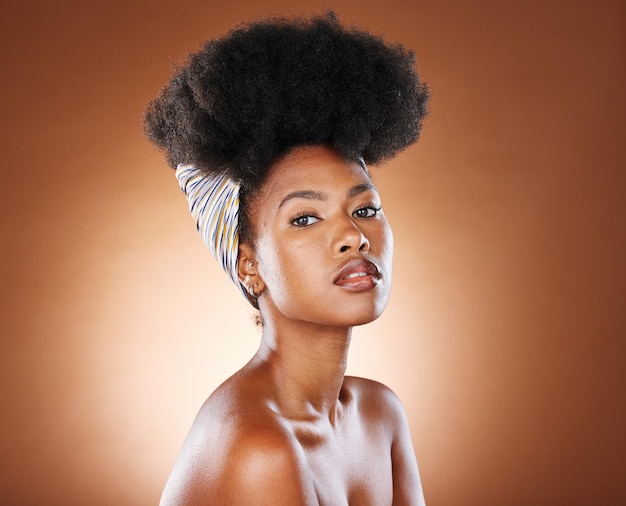 Black woman afro hair and fashion in beauty skincare cosmetics or makeup against a studio background Portrait of proud and confident African American female model with curly hairstyle treatment