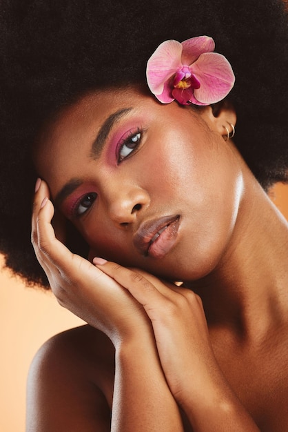 Black woman beauty and face flower and makeup with natural cosmetology advertising closeup African American model hands glow with skincare and cosmetics treatment portrait in studio