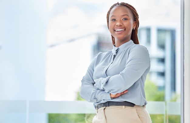 Black woman business portrait and happy entrepreneur with vision motivation and commitment at window of modern office agency Smile young and african manager proud employee and corporate worker