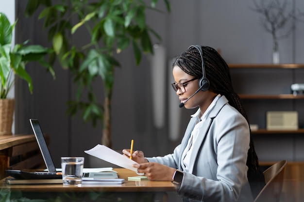 Black woman ceo executive discussing project results with team\
during weekly online meeting